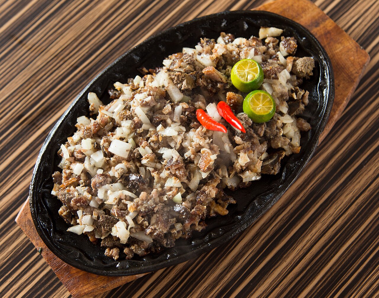 Authentic Kapampangan pork sisig on a sizzling plate